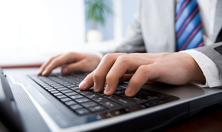 businessmans hands typing on keyboard