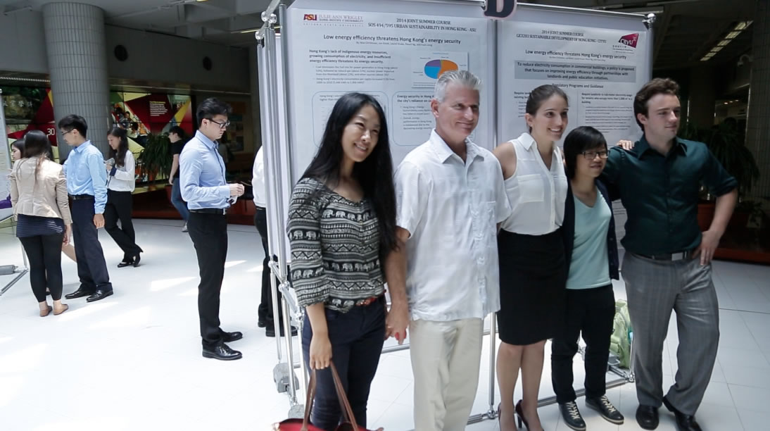 A team of ASU and CityU students proudly pose in front of their completed research posters.