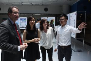 Students presenting research to CityU professors and scientists